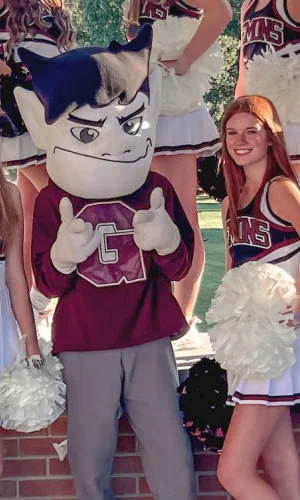 Cheerleaders forming a star with their arms