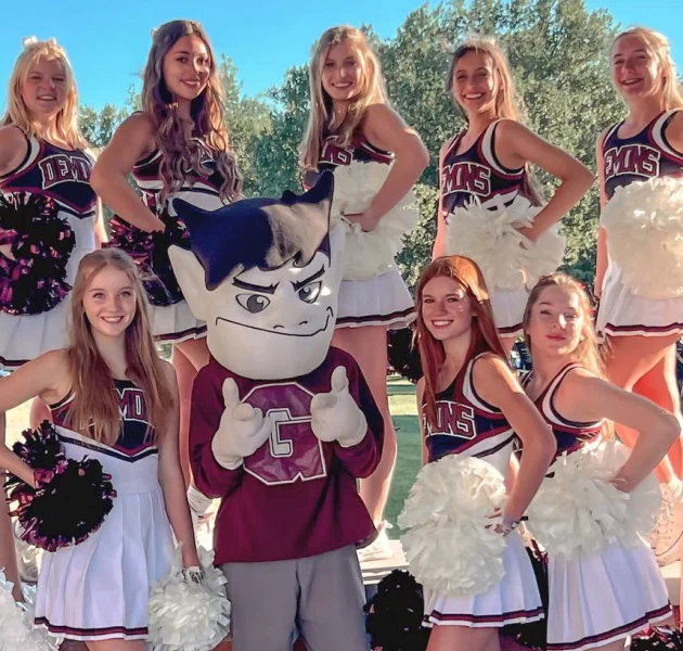 Cheerleaders forming a star with their arms