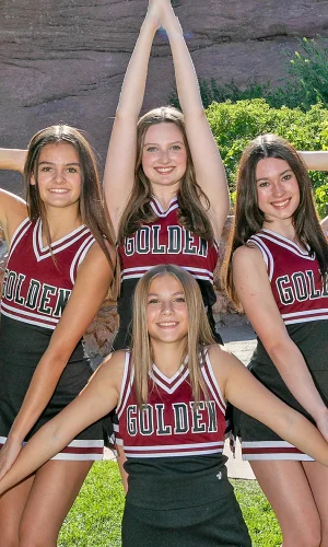 Cheerleaders forming a star with their arms