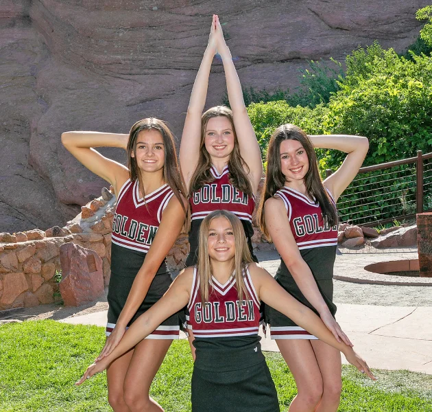 Cheerleaders forming a star with their arms